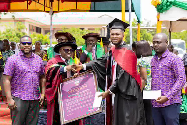 Seidu Joshua Adams being handed his award for the overall best-graduating student of the University of Energy and Natural Resources