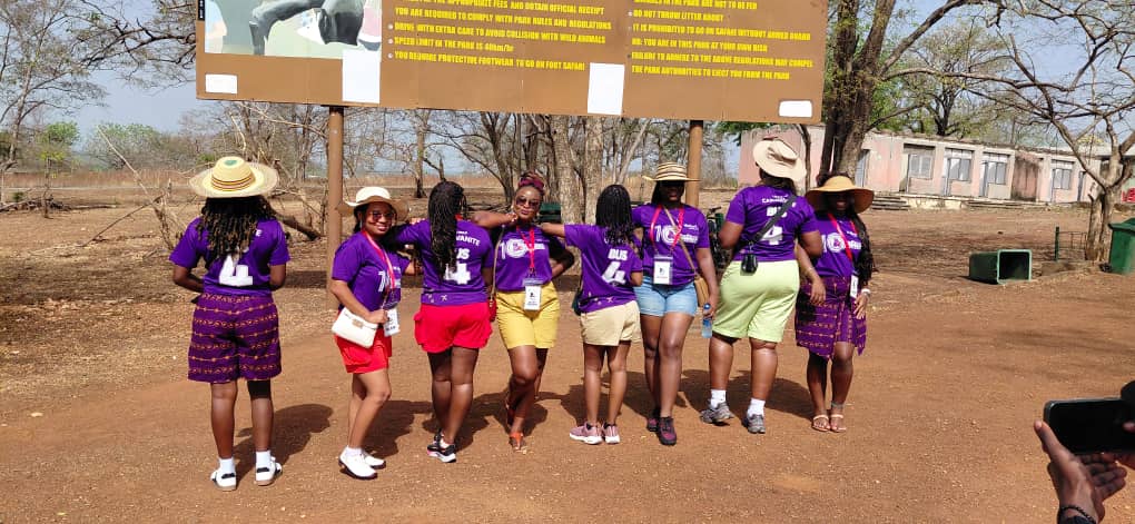 Patrons with branded Hollard T-shirts, posing by the billboard for at the Heritage Caravan expedition