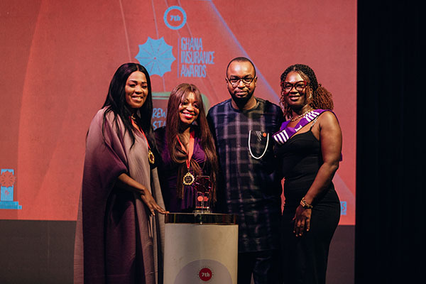 Hollard Ghana team on stage with their Coveted Customer Care Award at the Ghana Insurance Awards