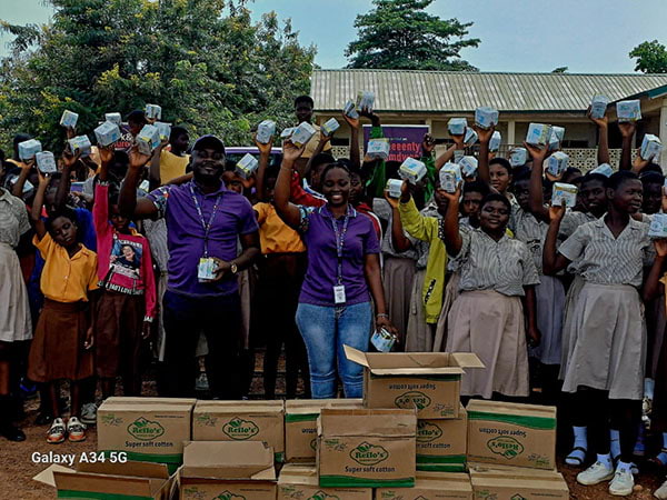 Hollard Ghana team and school children holding donated sanity pads