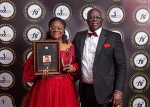 Hollard Ghana's Patience Akyianu and Mr Akyianu with her award
