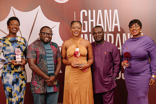 Hollard Ghana team with their Product Innovation Award on stage at the 2025 Ghana Insurance Awards