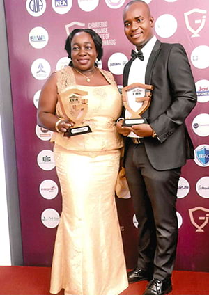 Two Hollard Insurance employees with their awards at the Maiden Chartered Insurance Institute Ghana Awards