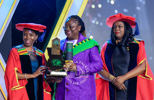 Hollard Group CEO, Patience Akyianu with her Millennium Excellence Award on stage